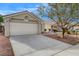 Inviting single-story home featuring a two-car garage, desert landscaping, and a well-maintained yard at 3417 Steppe St, North Las Vegas, NV 89032