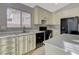 Kitchen featuring a large window, white countertops, off-white cabinets and black appliances at 3417 Steppe St, North Las Vegas, NV 89032