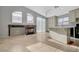 Open-concept kitchen featuring a fireplace, island, white cabinets, and stainless steel appliances at 3417 Steppe St, North Las Vegas, NV 89032