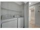 A laundry room featuring a washer, dryer, tile floors and a shelf at 3417 Steppe St, North Las Vegas, NV 89032