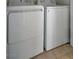 Close up of a white washing machine and dryer with tile flooring at 3417 Steppe St, North Las Vegas, NV 89032
