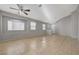 Open-concept living area featuring tiled floors, neutral paint, and large windows at 3417 Steppe St, North Las Vegas, NV 89032