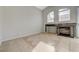 Bright living room with a fireplace, tile floors, and abundant natural light from multiple windows at 3417 Steppe St, North Las Vegas, NV 89032