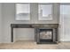 Fireplace with stone mantle and natural light entering the room from windows and a sliding glass door at 3417 Steppe St, North Las Vegas, NV 89032