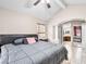 Comfortable bedroom features a ceiling fan, tiled floors, and an ensuite bathroom at 353 Seine Way # 0, Henderson, NV 89014