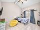Bedroom featuring neutral walls, tile floors, a yellow bean bag, and a window with blue curtains at 353 Seine Way # 0, Henderson, NV 89014