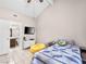 Comfortable bedroom featuring vaulted ceiling and tiled floors, adjacent to an ensuite bathroom at 353 Seine Way # 0, Henderson, NV 89014