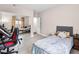 Cozy bedroom features tile floors, a closet with mirrored sliding doors, a queen bed, and small desk at 353 Seine Way # 0, Henderson, NV 89014