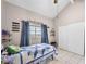 This bedroom features tile floors, a ceiling fan, a large window, and a built-in closet at 353 Seine Way # 0, Henderson, NV 89014