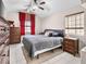 Spacious bedroom with tiled floors, a ceiling fan, and large windows with red curtains at 353 Seine Way # 0, Henderson, NV 89014