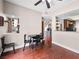 Bright dining area features a ceiling fan, wood floors, and dark wooden table set with four chairs at 353 Seine Way # 0, Henderson, NV 89014