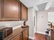 Hallway featuring hardwood floors, wooden cabinets, and a view of the second story at 353 Seine Way # 0, Henderson, NV 89014