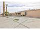 Expansive backyard with concrete flooring, a covered patio and palm trees at 4213 Hayes Pl, Las Vegas, NV 89107