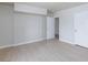 Bright bedroom featuring light wood floors, neutral walls, and a closet with modern doors at 4213 Hayes Pl, Las Vegas, NV 89107