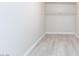 Walk in closet with custom hanging system and wood look floors at 4213 Hayes Pl, Las Vegas, NV 89107