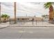 Charming single-story home featuring palm trees and a wrought iron fence at 4213 Hayes Pl, Las Vegas, NV 89107