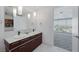 Bathroom boasts double sinks, modern lighting, and sleek fixtures, leading to a bedroom with city views at 4471 Dean Martin Dr # 1202, Las Vegas, NV 89103