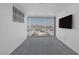 Bright bedroom with carpet, large window showcasing the city skyline at 4471 Dean Martin Dr # 1202, Las Vegas, NV 89103
