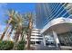 Exterior shot of the high-rise building with elegant canopy entrance and palm trees at 4471 Dean Martin Dr # 1202, Las Vegas, NV 89103