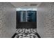 Hallway with decorative tile flooring and a modern art installation in the distance at 4471 Dean Martin Dr # 1202, Las Vegas, NV 89103