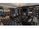 Stylish living room with black leather furniture, bookshelves, fireplace, and patterned carpet at 4471 Dean Martin Dr # 1202, Las Vegas, NV 89103