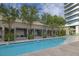 A modern pool with private lounging areas and a view of the building's upper levels at 4471 Dean Martin Dr # 1202, Las Vegas, NV 89103