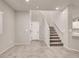 Bright entryway showcases a staircase and white doors against neutral-colored walls and tile flooring at 4472 Sapphire Moon Ave, North Las Vegas, NV 89084