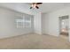 Bright and airy bedroom with neutral carpet, ceiling fan, and windows offers a cozy feel at 470 Dorchester Bend Ave # 3, North Las Vegas, NV 89032
