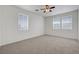 Bright bedroom features neutral carpet, ceiling fan and lots of natural light from two large windows at 470 Dorchester Bend Ave # 3, North Las Vegas, NV 89032