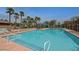 Sparkling community pool with lounge chairs and palm trees, creating a resort-like atmosphere at 470 Dorchester Bend Ave # 3, North Las Vegas, NV 89032