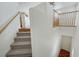 Bright staircase with carpeted steps and wooden railings, leading to the upper level at 470 Dorchester Bend Ave # 3, North Las Vegas, NV 89032
