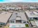 Expansive aerial view showcases the residence, sparkling pool/spa, outdoor kitchen, and lush landscaping at 477 Highview Ridge Ave, Las Vegas, NV 89138