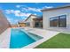 Stunning backyard featuring a sleek pool and spa combo, outdoor kitchen, and modern landscaping at 477 Highview Ridge Ave, Las Vegas, NV 89138
