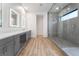 The bathroom has a large glass shower, dual vanity with illuminated mirrors, and modern fixtures at 477 Highview Ridge Ave, Las Vegas, NV 89138