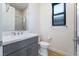 Bathroom featuring grey vanity, white counter top, wood-look flooring, and a shower at 477 Highview Ridge Ave, Las Vegas, NV 89138