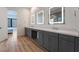 The bathroom has a dual vanity with modern fixtures, and illuminated mirrors at 477 Highview Ridge Ave, Las Vegas, NV 89138