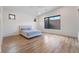 Spacious bedroom featuring wood-look flooring, neutral walls, and bright natural light at 477 Highview Ridge Ave, Las Vegas, NV 89138