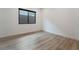 Clean bedroom featuring wood-look floors and bright window letting in natural light at 477 Highview Ridge Ave, Las Vegas, NV 89138