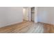 Clean bedroom featuring wood-look floors, white walls, closet, and simple modern design at 477 Highview Ridge Ave, Las Vegas, NV 89138
