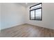 Bright bedroom featuring wood-look floors and modern windows letting in natural light at 477 Highview Ridge Ave, Las Vegas, NV 89138