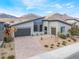 Stunning modern home featuring desert landscaping, a brick driveway, and mountain views at 477 Highview Ridge Ave, Las Vegas, NV 89138