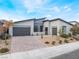 Stunning modern home featuring desert landscaping and a brick driveway at 477 Highview Ridge Ave, Las Vegas, NV 89138