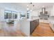 Open-concept kitchen with island, stainless appliances, hardwood floors and sleek design at 477 Highview Ridge Ave, Las Vegas, NV 89138