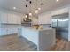 Spacious kitchen featuring an island with marble counter, stainless steel appliances, and modern lighting at 477 Highview Ridge Ave, Las Vegas, NV 89138