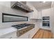 Modern kitchen features a professional gas range with stainless hood and designer finishes at 477 Highview Ridge Ave, Las Vegas, NV 89138