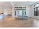 Open living area flows to dining space with wood-style floors and sliding glass door at 477 Highview Ridge Ave, Las Vegas, NV 89138