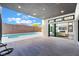 The covered outdoor patio provides seamless indoor-outdoor living with views of the pool and surrounding landscape at 477 Highview Ridge Ave, Las Vegas, NV 89138