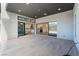Modern patio with tile flooring and sliding glass doors that open to the kitchen and backyard at 477 Highview Ridge Ave, Las Vegas, NV 89138