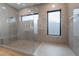 The frameless shower has gray stone tile, a window, and a built-in bench at 477 Highview Ridge Ave, Las Vegas, NV 89138