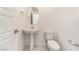Clean half bathroom with pedestal sink and modern fixtures next to the front entry at 4915 Chidlaw Ave # 2, Las Vegas, NV 89115